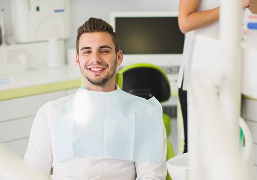 Man smiling in dental chair after dental checkup