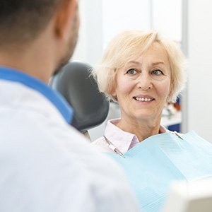 woman smiling while talking to dentist