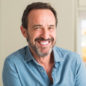 man smiling after getting dental implants